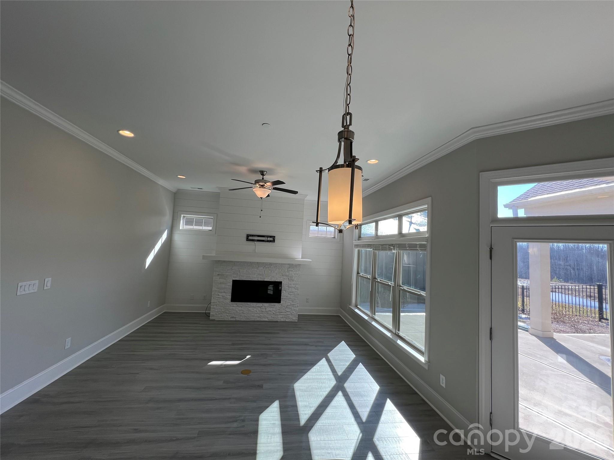 9049 Treetop Way Northwest Concord, NC 28027 - Photo 7 of 42 a view of empty room with wooden floor and fan