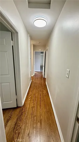 a view of room with wooden floor
