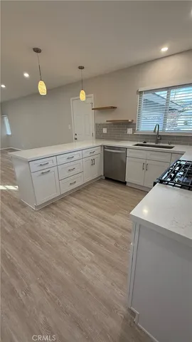 a kitchen with white cabinets and white appliances