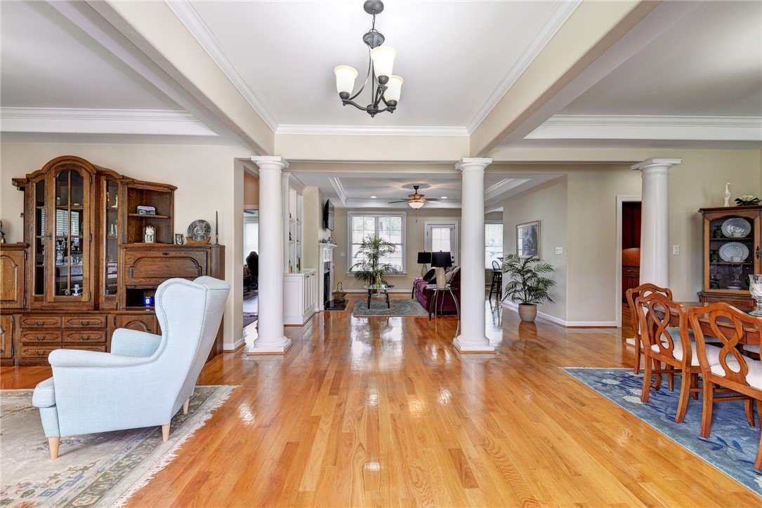 11 Butler Farm Road Hampton, VA 23666 - Photo 6 of 39 Entrance foyer with a ceiling fan, light wood-style flooring, ornate columns, crown molding, and a chandelier