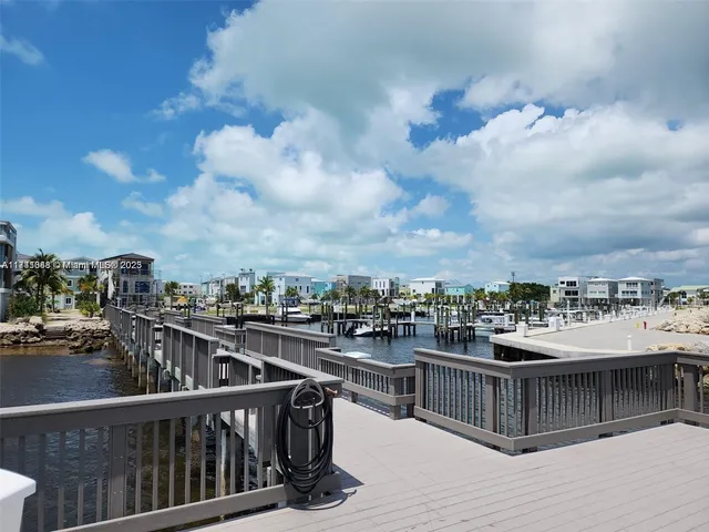 a view of a roof deck with two couches and wooden floor