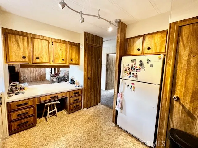 a kitchen with stainless steel appliances a refrigerator sink and cabinets