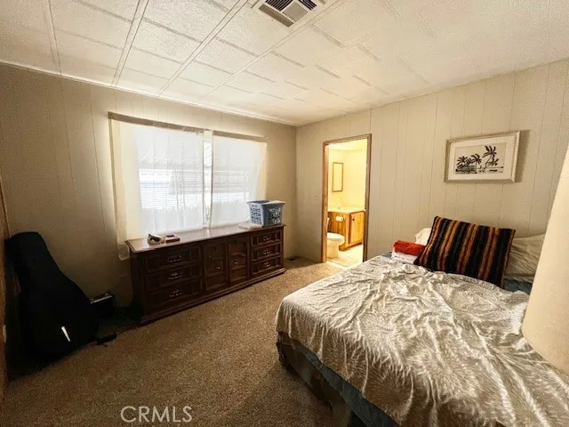 a bed room with a bed and a television