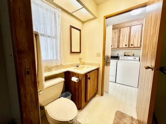 a bathroom with a toilet a sink and a mirror