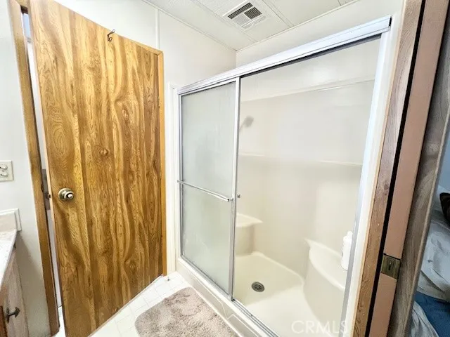 a bathroom with a glass shower door and a sink