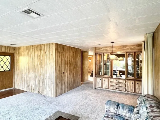 a view of a livingroom with furniture and floor to ceiling window