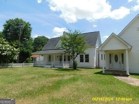 a front view of house with yard and green space