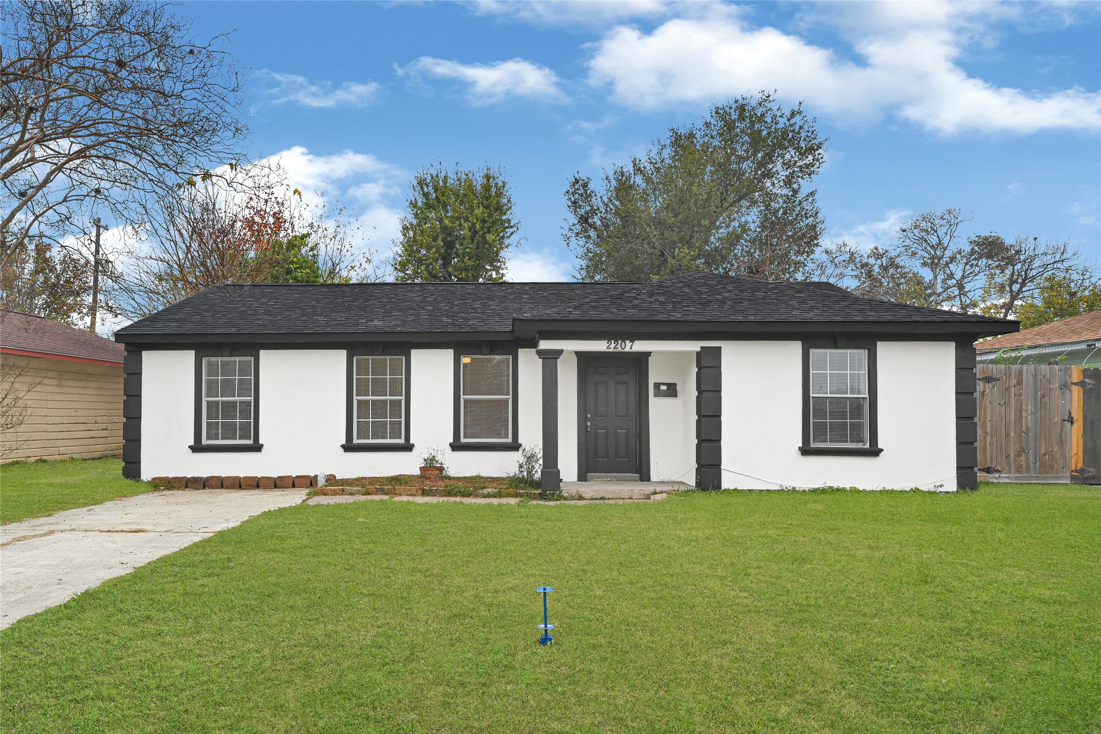 2207 Raymond Street Pasadena, TX 77506 - Photo 2 of 21 a front view of a house with a garden and yard