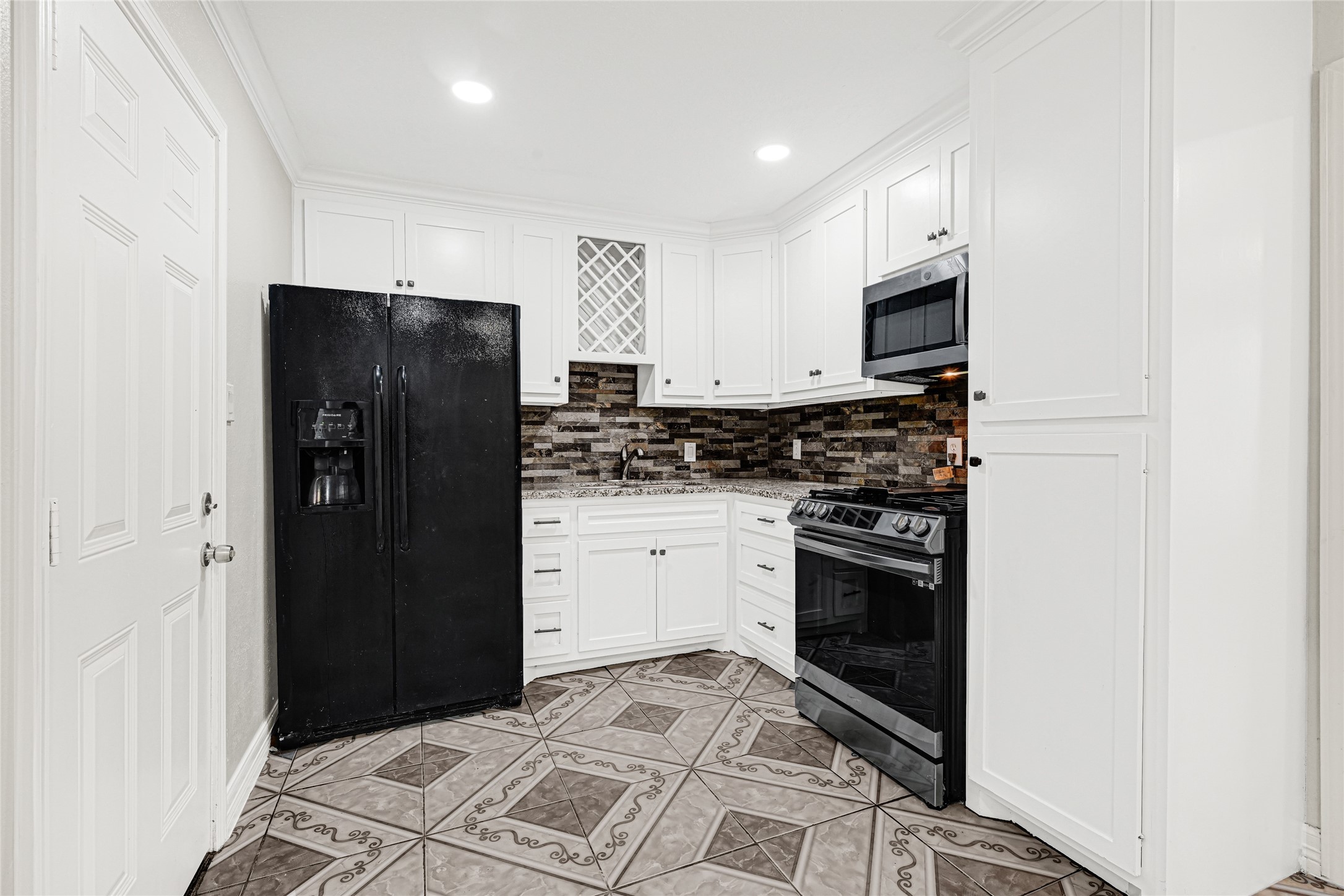 2207 Raymond Street Pasadena, TX 77506 - Photo 8 of 21 a kitchen with stainless steel appliances a refrigerator stove and microwave