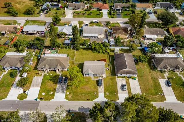 an aerial view of residential house with parking