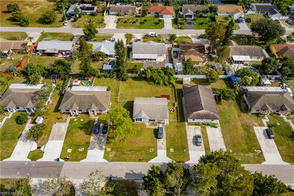 2100 55th Terrace Southwest Naples, FL 34116 - Photo 23 of 33 an aerial view of residential houses with outdoor space and parking