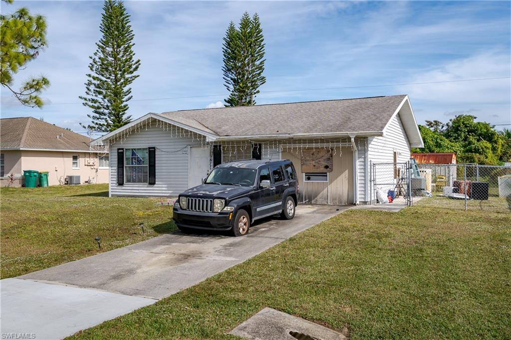 2100 55th Terrace Southwest Naples, FL 34116 - Photo 3 of 33 a front view of a house with garden