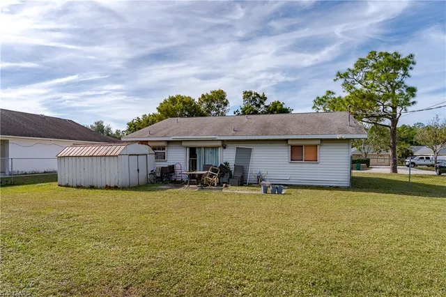 a view of a house with a yard and sitting area