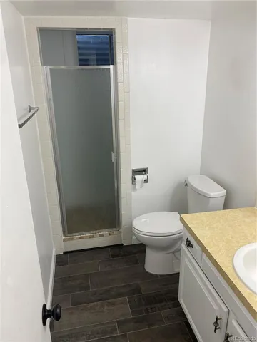 a bathroom with a toilet and a shower