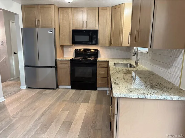 a kitchen with a refrigerator sink and microwave