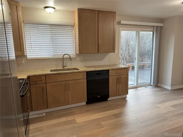 a kitchen with a sink cabinets and window