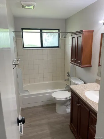 a bathroom with a sink a toilet a mirror a bathtub and shower