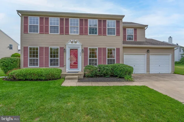 a view of brick house with a yard