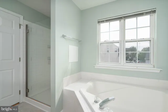 a bath tub sitting next to a window