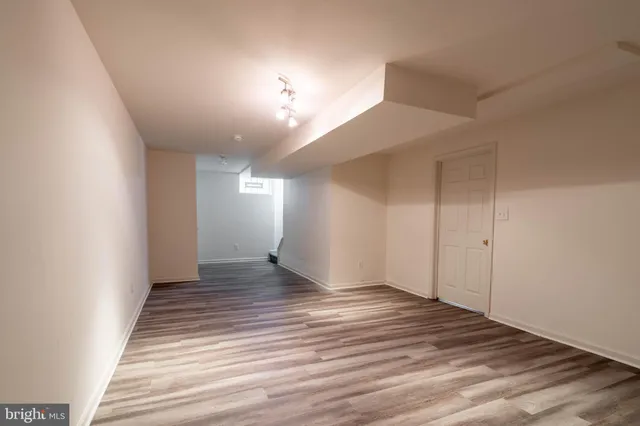 a view of an empty room and wooden floor