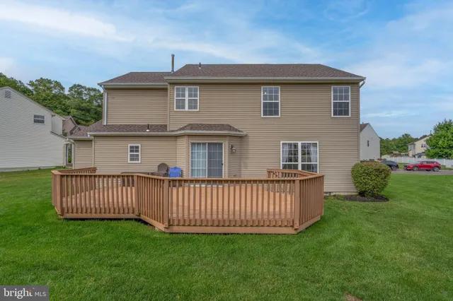 a view of a house with a yard and deck