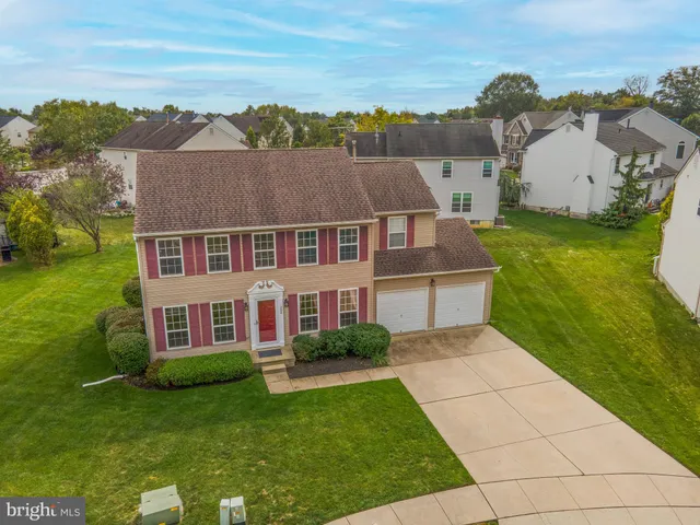 an aerial view of multiple houses with a yard