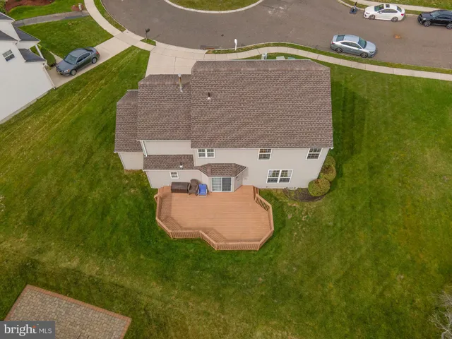 an aerial view of a house with backyard