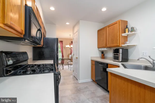a kitchen with stainless steel appliances granite countertop a stove and a sink
