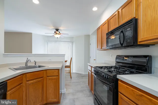 a kitchen with a stove a sink and a microwave