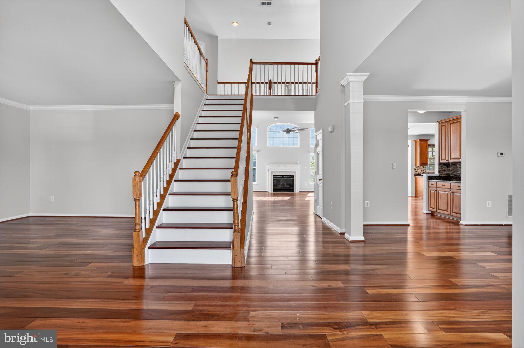 Spacious entryway with elegant staircase.