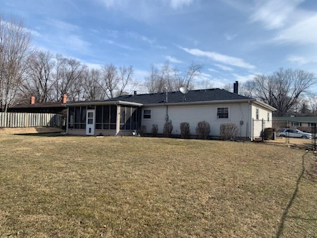 5015 Highcrest Road Rockford, IL 61107 - Photo 11 of 12 a front view of house with yard and trees in the background