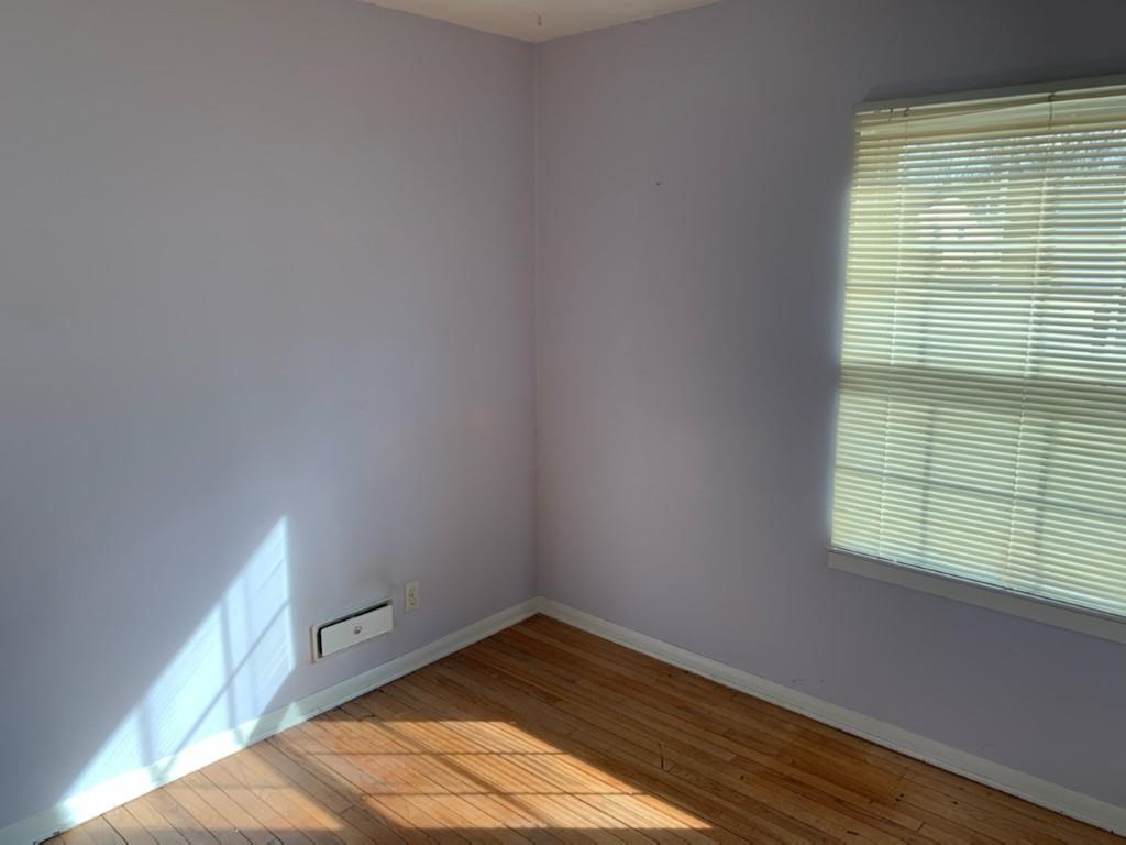 5015 Highcrest Road Rockford, IL 61107 - Photo 6 of 12 a view of an empty room with wooden floor and a window