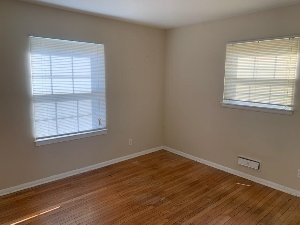 5015 Highcrest Road Rockford, IL 61107 - Photo 7 of 12 an empty room with wooden floor and windows