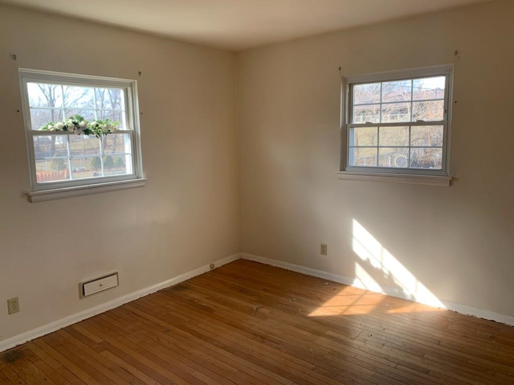 5015 Highcrest Road Rockford, IL 61107 - Photo 8 of 12 a view of empty room with wooden floor and fan