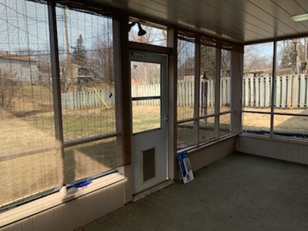 5015 Highcrest Road Rockford, IL 61107 - Photo 9 of 12 a view of an empty room with a sliding door