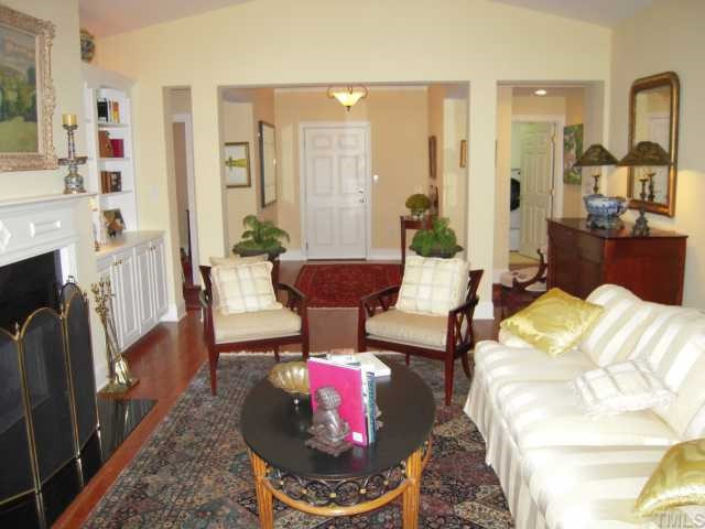 3700 Baron Cooper Pass, Unit 201 Raleigh, NC 27612 - Photo 2 of 12 Living Room is Open to Entry Foyer and Has Built In Bookshelves Living Room