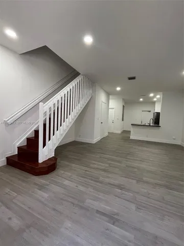 a view of an entryway wooden floor and windows