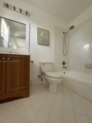 a bathroom with a toilet a sink and bathtub
