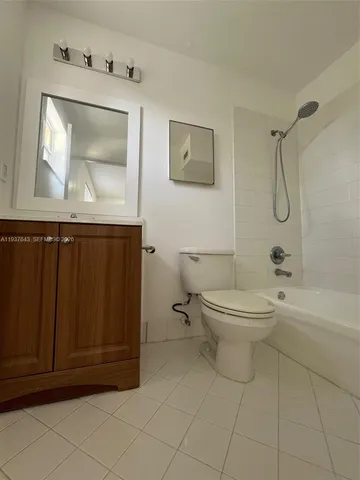 a bathroom with a toilet a sink and bathtub