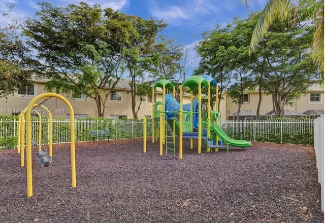a view of outdoor space with playground and green space