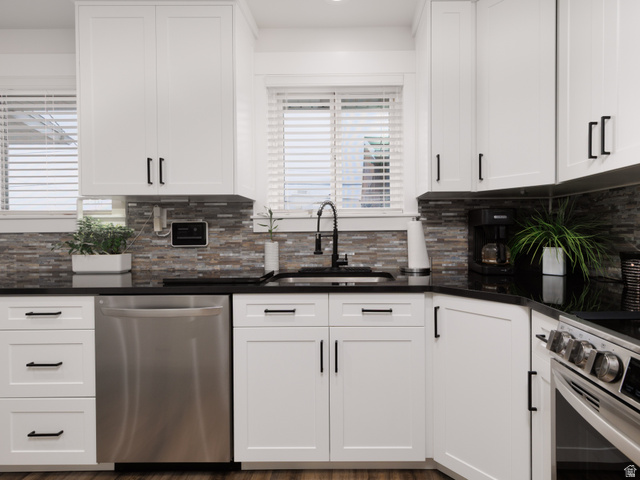 8252 Wood Street Midvale, UT 84047 - Photo 5 of 40 Kitchen with black granite countertops and stainless steel appliances