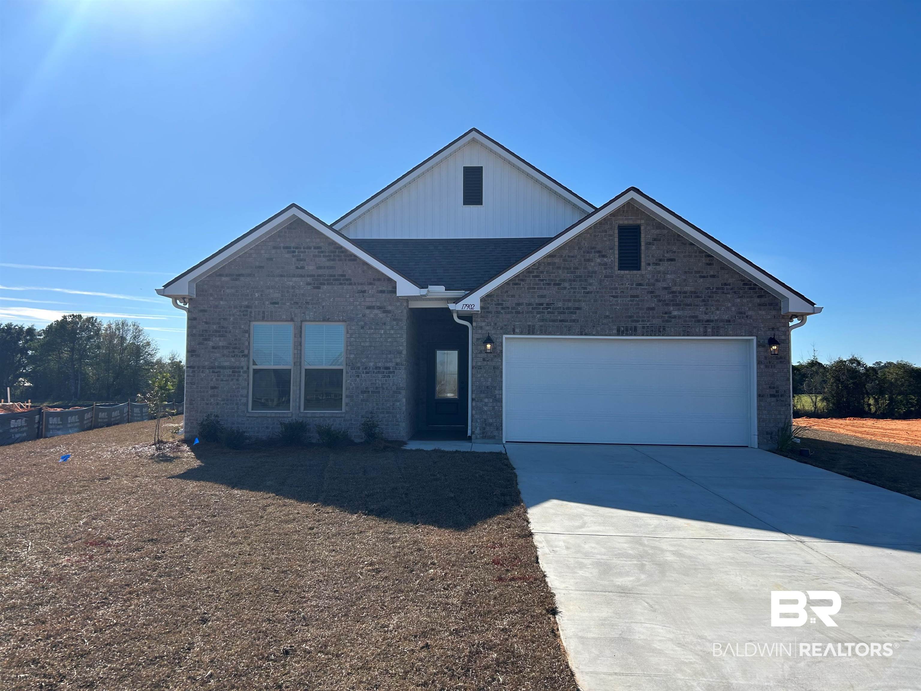 17902 Piney Circle Foley, AL 36535 - Photo 1 of 3 View of front facade featuring brick siding, driveway, an attached garage, and board and batten siding