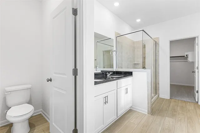 an empty room with chandelier fan and windows