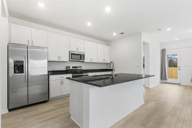 a view of kitchen with wooden floor and window