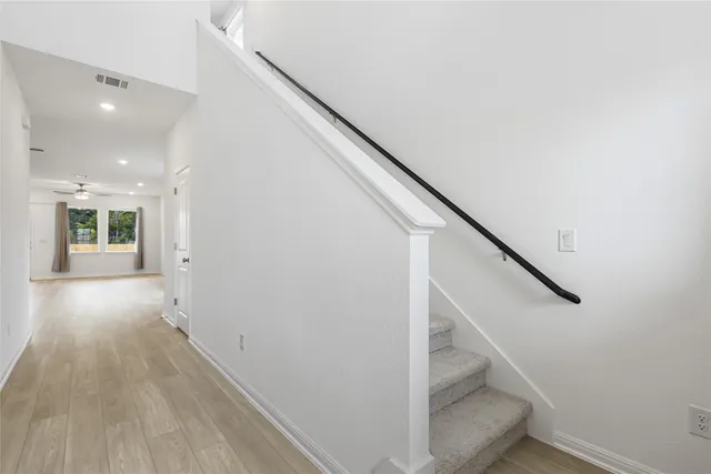 a kitchen with stainless steel appliances granite countertop a refrigerator sink and white cabinets