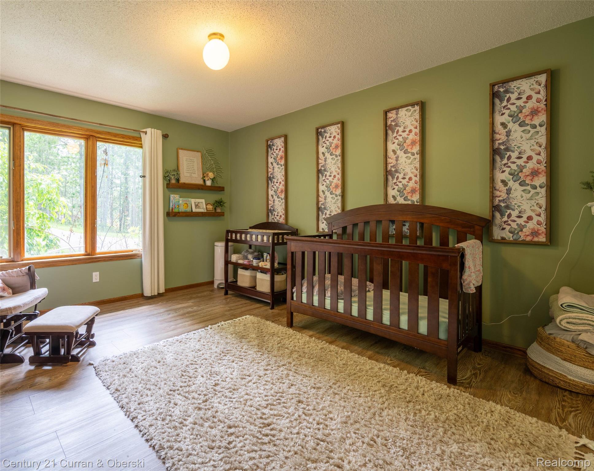 8775 Winding Rdg Drive Millersburg, MI 49759 - Photo 28 of 53 Room with wood-finish flooring, light green walls, and large multi-pane windows