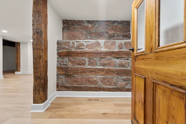 a living room with furniture a table and a potted plant