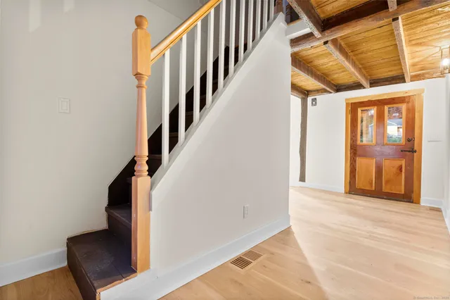 a view of a room with wooden floor and stairs