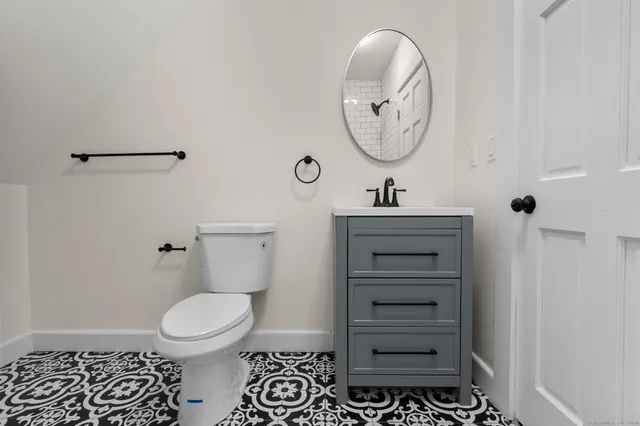 a bathroom with a toilet a sink and bathtub