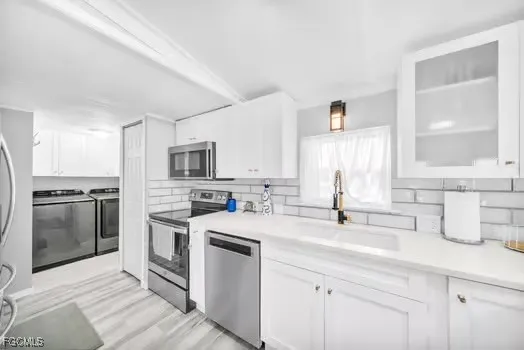 a kitchen with a sink and stainless steel appliances